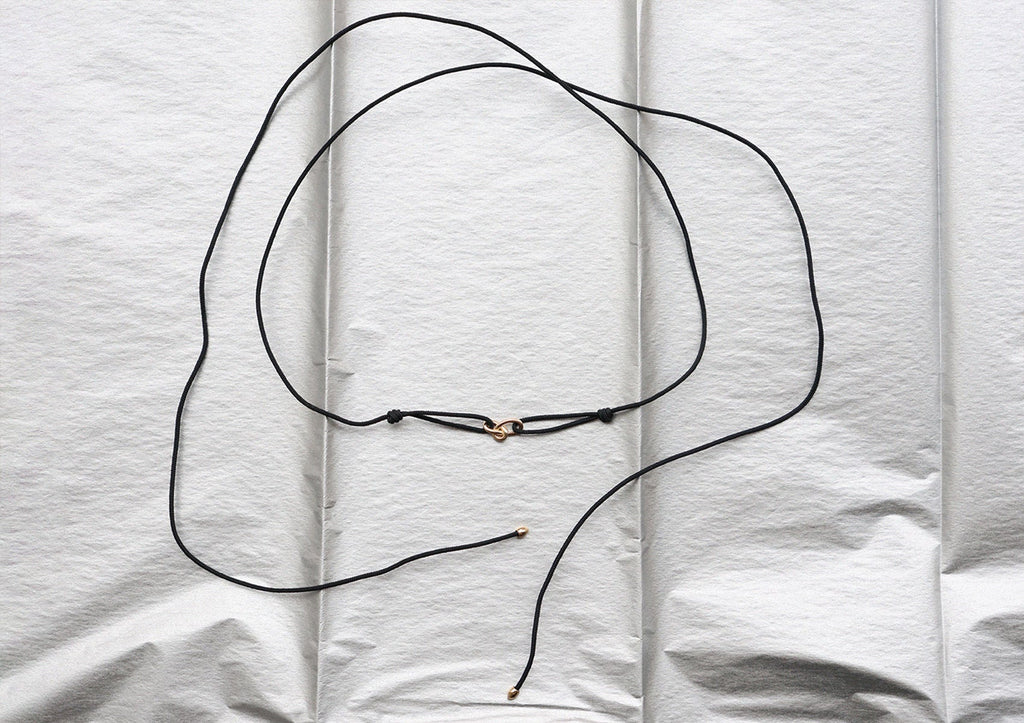 https://ik.imagekit.io/fzkghjurk1l/resize-external/https://storage.googleapis.com/shop_images/Akind/AKIND_GoldKnotCordNecklace_Enviro.jpg?tr=w-2000,h-2000,c-at_max,f-jpg,bg-white