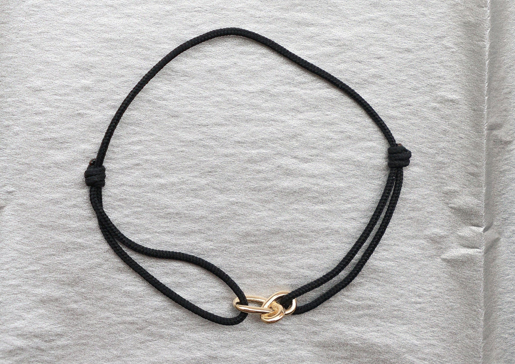 https://ik.imagekit.io/fzkghjurk1l/resize-external/https://storage.googleapis.com/shop_images/Akind/AKIND_GoldKnotCordBracelet_Enviro.jpg?tr=w-2000,h-2000,c-at_max,f-jpg,bg-white