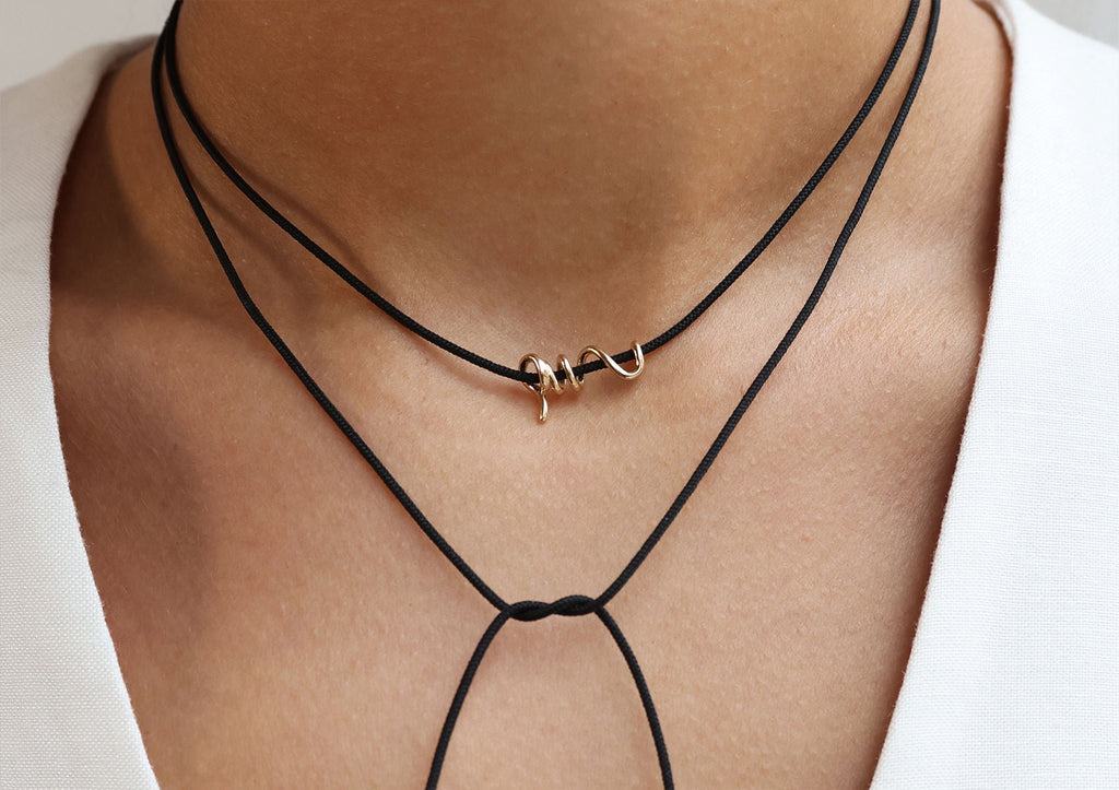 https://ik.imagekit.io/fzkghjurk1l/resize-external/https://storage.googleapis.com/shop_images/Akind/AKIND_GoldSpiralCordNecklace_2.jpg?tr=w-2000,h-2000,c-at_max,f-jpg,bg-white