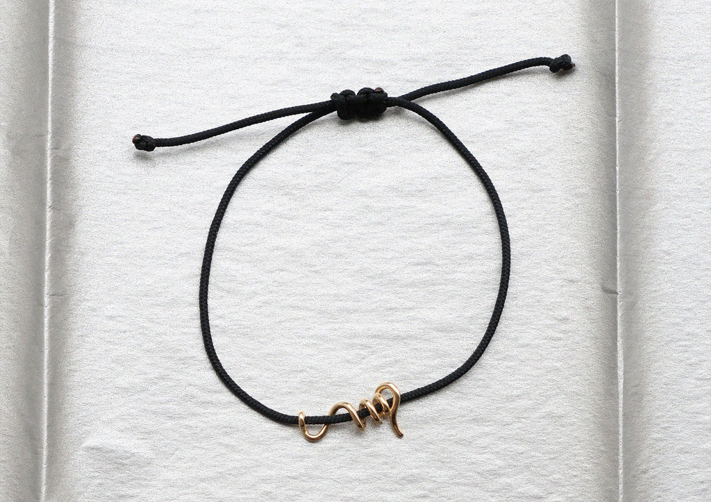 https://ik.imagekit.io/fzkghjurk1l/resize-external/https://storage.googleapis.com/shop_images/Akind/AKIND_GoldSpiralCordBracelet_Enviro.jpg?tr=w-2000,h-2000,c-at_max,f-jpg,bg-white
