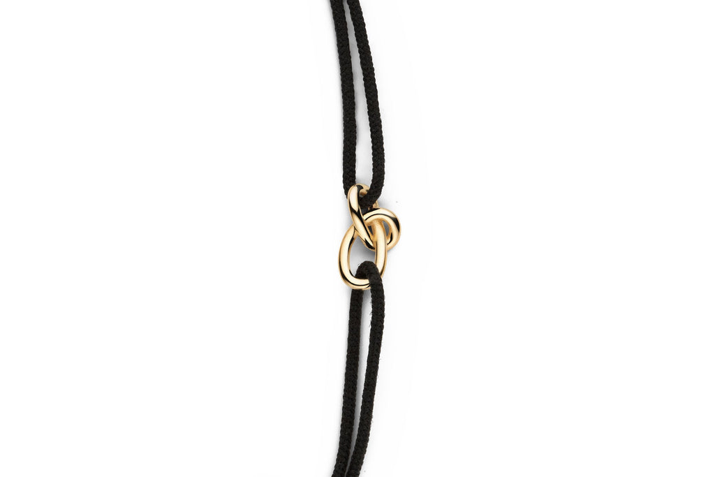 https://ik.imagekit.io/fzkghjurk1l/resize-external/https://storage.googleapis.com/shop_images/Akind/AKIND_GoldKnotCordBracelet_Studio2.png?tr=w-2000,h-2000,c-at_max,f-jpg,bg-white
