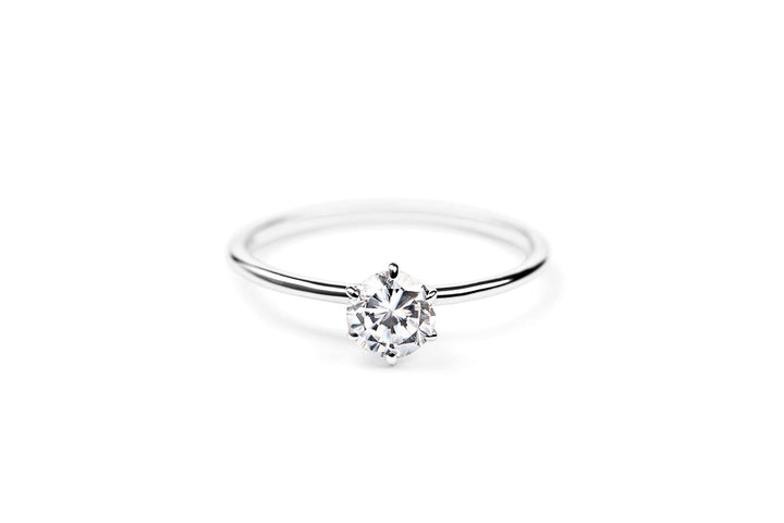 https://ik.imagekit.io/fzkghjurk1l/resize-external/https://storage.googleapis.com/shop_images/Akind/AKIND_SixProngDiamondRing0.5ct_Laying_WG_Studio.png?tr=w-2000,h-2000,c-at_max,f-jpg,bg-white